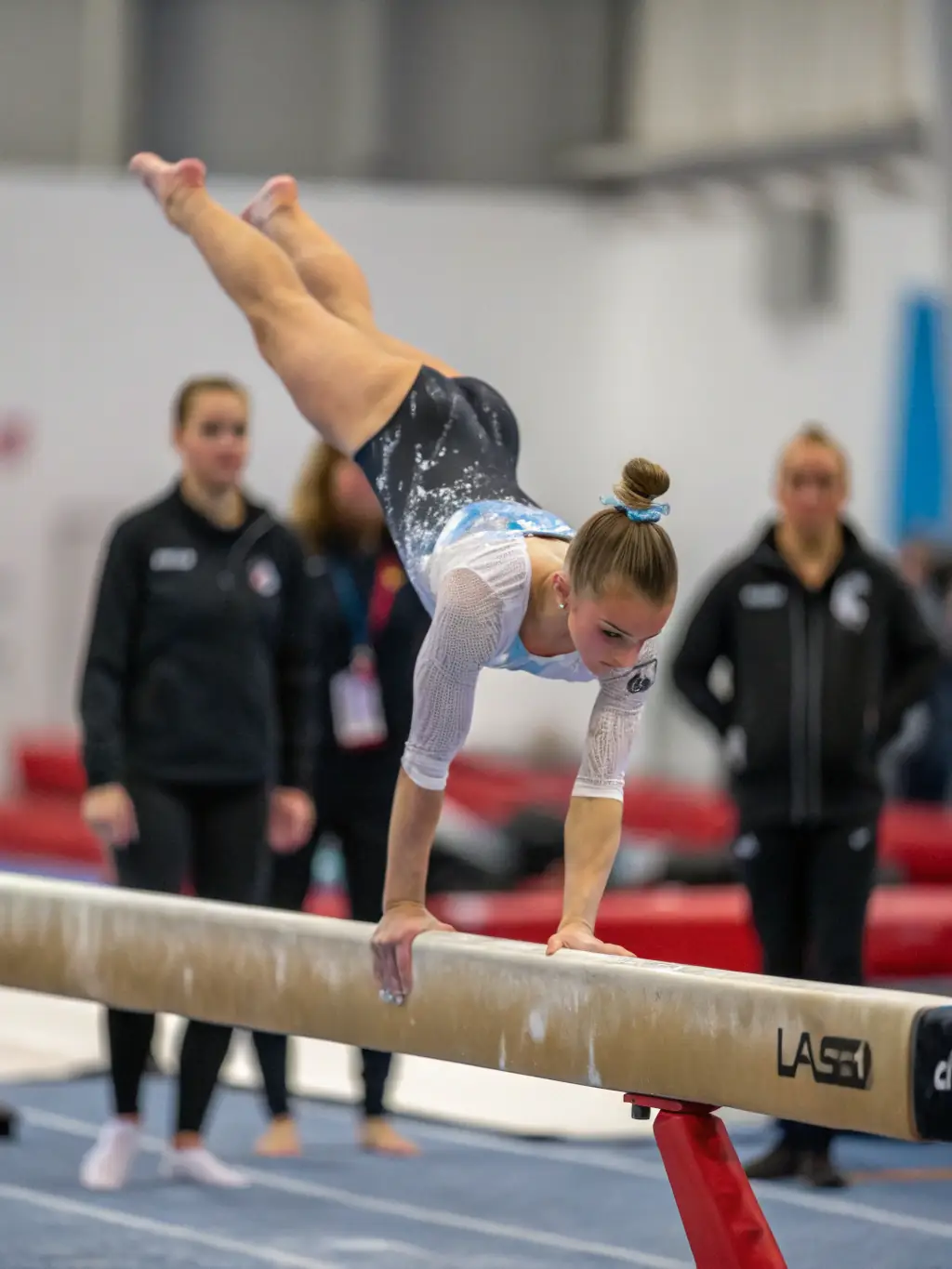 An image of young gymnasts practicing on the balance beam, emphasizing balance and concentration.